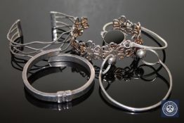 Four sterling silver and one white metal bangle (5)