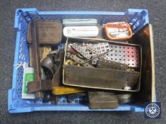 A basket of two vintage woodworking planes, vintage tins,