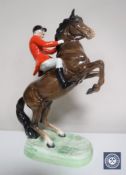 A Beswick figure of a huntsman on rearing horse,