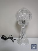 A cut glass table lamp with shade