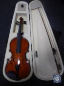 A full-size violin in case with bow