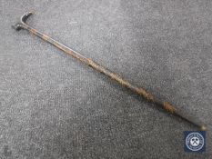 A sword stick in carved wooden sheath CONDITION REPORT: Generally in good condition.