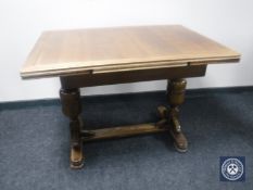A 20th century oak pull out dining table