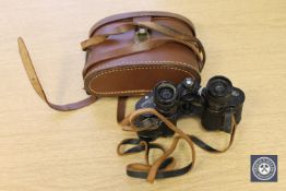 A pair of Charles Frank binoculars, 8 x 25, in brown leather case.