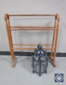 A stripped pine towel rail together with a metal and glass light fitting in the form of a lantern