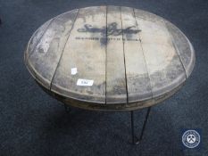 An oak whisky barrel lid coffee table bearing advertising