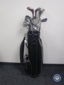 A leather golf bag containing Splalding Diplomat drivers,