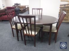 An oval inlaid mahogany dining table and four rail back chairs,