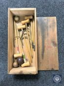 An early 20th century miniature croquet set in pine box