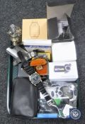 A tray containing digital cameras, mobile phones, table lighters, smart watch,