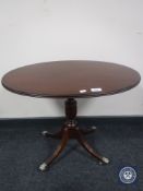 A Regency style mahogany oval topped wine table