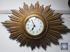 A gilt wood sunburst clock with battery movement