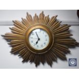 A gilt wood sunburst clock with battery movement