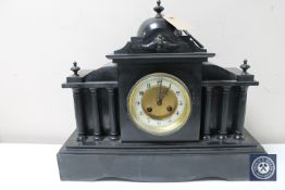 A Victorian slate mantel clock with brass and enamel dial