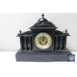 A Victorian slate mantel clock with brass and enamel dial