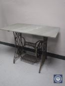 A Singer treadle sewing machine base with granite top