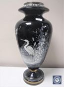A Victorian black glass vase with white painted decoration depicting a heron CONDITION