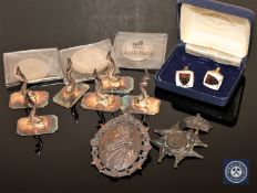 A wooden trinket box containing a set of six Portuguese silver plated menu holders in the form of