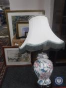 A floral pottery table lamp and a quantity of framed prints