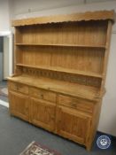 A pine farmhouse dresser fitted with cupboards and drawers beneath, width 171 cm.