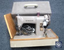 A vintage Singer electric sewing machine in case