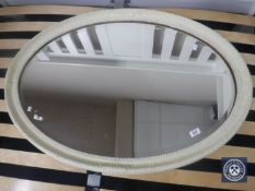 A Victorian oval painted framed mirror