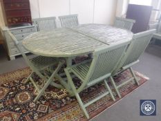 A painted teak extending garden table and six chairs CONDITION REPORT: Paint is