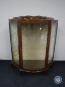 A mid 20th century walnut D-shaped display cabinet