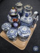 A tray of blue and white oriental style china, lidded vases, ginger jars,