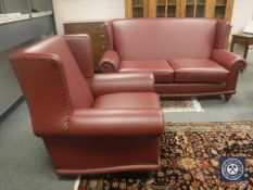 A buttoned burgundy three seater settee (length 195 cm), together with the matching armchair.