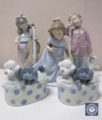 Five Nao figures including boy with teddy bear, girl with puppy,