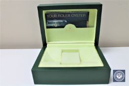 A green Rolex wristwatch box with two Rolex Datejust manuals
