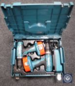 A cased set of two Makita 18 volt electric drills with batteries and chargers