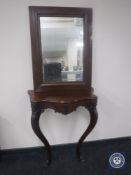 A mahogany hall table and a mahogany framed mirror