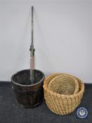 An oak coopered bucket together with two wicker baskets and an antique brass rail