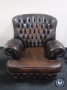 A brown buttoned leather Chesterfield style armchair