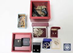 A box of various silver and costume jewellery, several pairs of silver earrings,