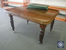 A Victorian mahogany wind out dining table