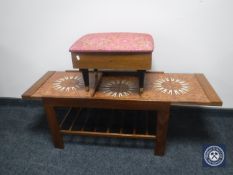 A mid 20th century teak extending tiled topped coffee table and teak sewing box footstool