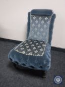 An Edwardian bedroom chair in blue button fabric
