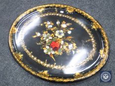 An oval Victorian papier-mache tray with mother of pearl inlay