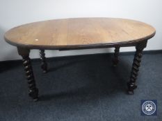 A Victorian oak barley twist wind out dining table