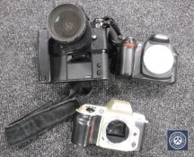 Three Nikon cameras CONDITION REPORT: Contains a Nikon Af Nikkor 28-100mm lens with