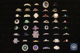 Forty-four silver dress rings, variously set with amethysts, synthetic emeralds,