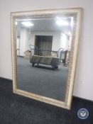 A contemporary cream and gilt framed overmantel mirror