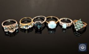 Six silver dress rings set with blue stones (6)