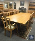 A contemporary light oak dining table (length 274 cm), on wrought iron understretcher,