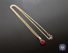 A garnet drop pendant on 9ct gold chain
