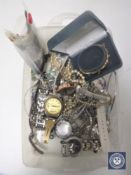 A box containing costume jewellery, banknotes, crowns, wristwatch, silver jewellery,