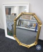 A contemporary octagonal bevelled mirror together with a white picture mirror